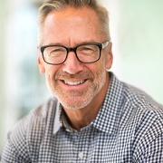 Smiling senior man with glasses and All-on-X dentures