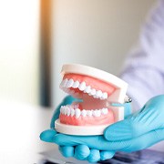 dental professional holding dentures