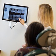 Dentist and patient looking at x-rays before root canal therapy