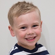 Child smiling after treatment for thumb sucking