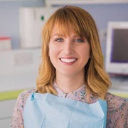 Smiling dental patient after dental crown restoration