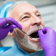 Man receiving dental crown supported fixed bridge