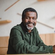 man smiling while holding glasses