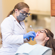 Woman discussing dental implant treatment with dentist