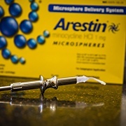 Arestin antibiotic therapy system