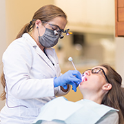 Woman talking to dentist during preventive dentistry visit