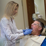 Dentist performing tooth extraction