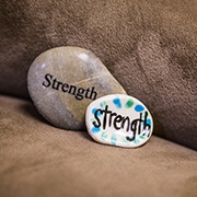 Rocks with the word strength painted on them