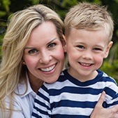 Smiling mother and child after preventive dentistry