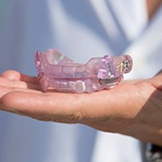 Hand holding a T M J therapy oral appliance