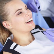 Happy dental patient during tooth colored filling treatment