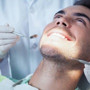 Man's dental checkup after tooth colored filling treatment