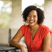 Woman smiling after porcelain veneer placement