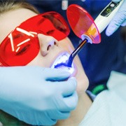 In-office teeth whitening treatment on female patient