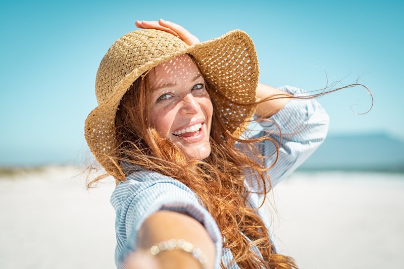 woman smiling at beach during summer