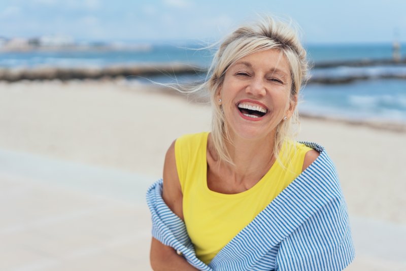 Woman on a beach during summer smiling