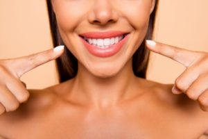 Woman smiling after receiving cosmetic dentistry