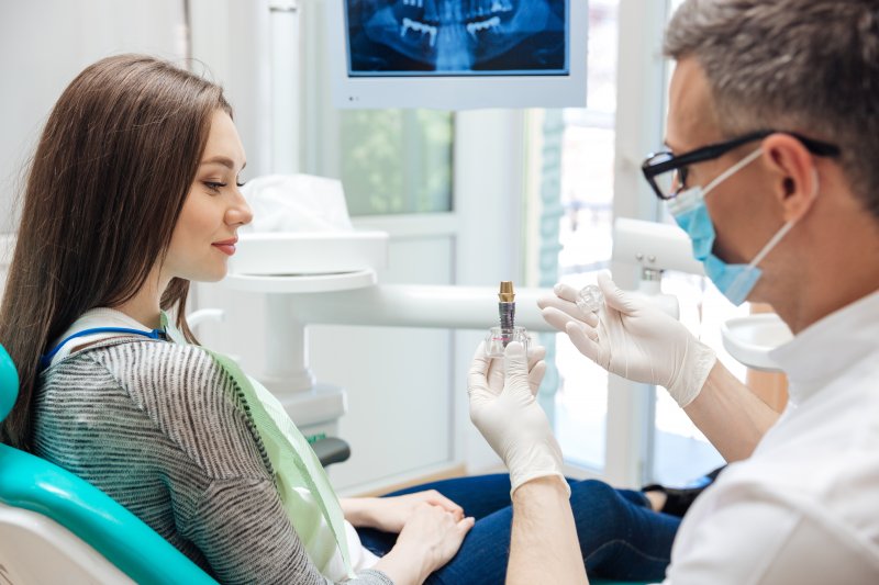 A dentist explaining dental implants to his patient